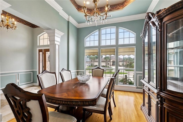 10 Harbor Cv, Slidell, LA 70458 - dining room featuring a chandelier, decorative columns, a wainscoted wall, ornamental molding, and a decorative wall