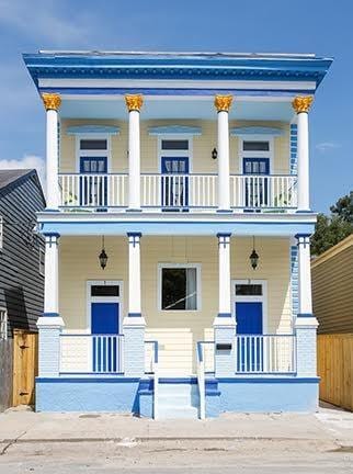 1241 Kerlerec St, New Orleans, LA 70116 - neoclassical / greek revival house with covered porch, a balcony, and fence