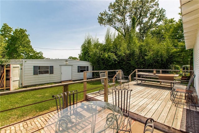 245 E Oak St, Ponchatoula, LA 70454 - wooden deck featuring outdoor dining space, a lawn, and an outdoor structure