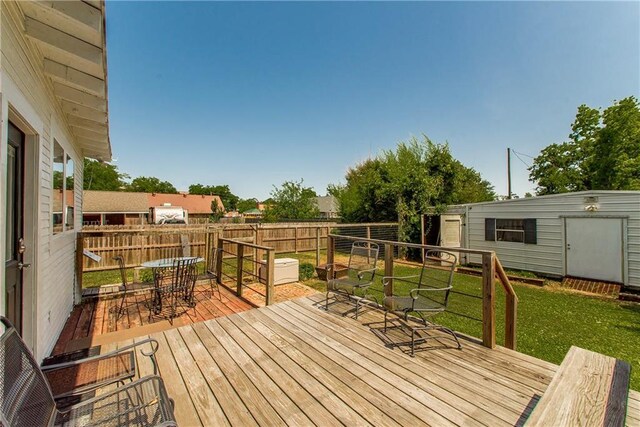 245 E Oak St, Ponchatoula, LA 70454 - wooden terrace featuring outdoor dining space and an outdoor structure