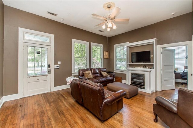 245 E Oak St, Ponchatoula, LA 70454 - living room with light wood-style floors, a ceiling fan, and baseboards