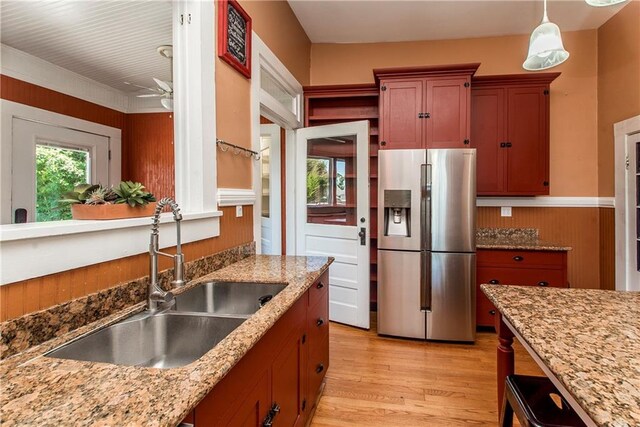 245 E Oak St, Ponchatoula, LA 70454 - kitchen with stainless steel fridge with ice dispenser, a sink, light wood-style floors, light stone counters, and ceiling fan