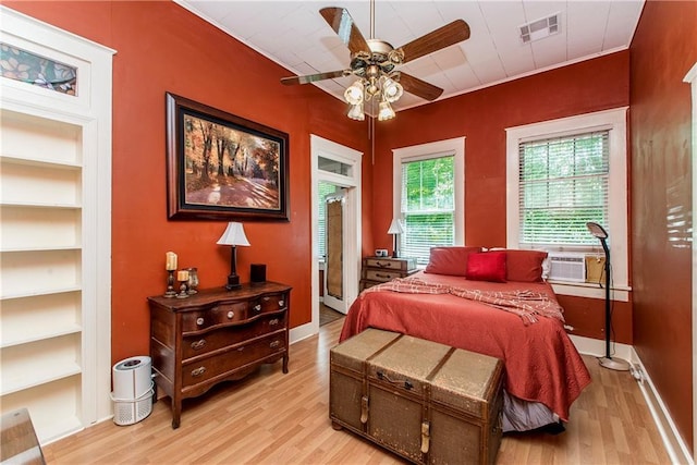 245 E Oak St, Ponchatoula, LA 70454 - bedroom with light wood finished floors, cooling unit, and baseboards