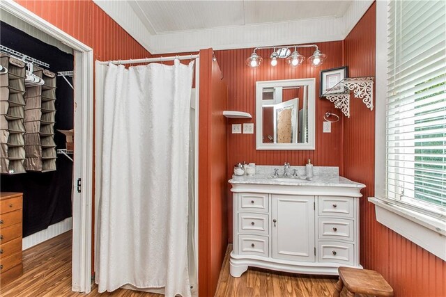245 E Oak St, Ponchatoula, LA 70454 - full bath with wood finished floors, vanity, a shower with shower curtain, and ornamental molding