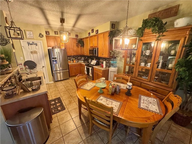 2132 Wellington Ln, Slidell, LA 70461 - dining room with light tile patterned flooring and a textured ceiling
