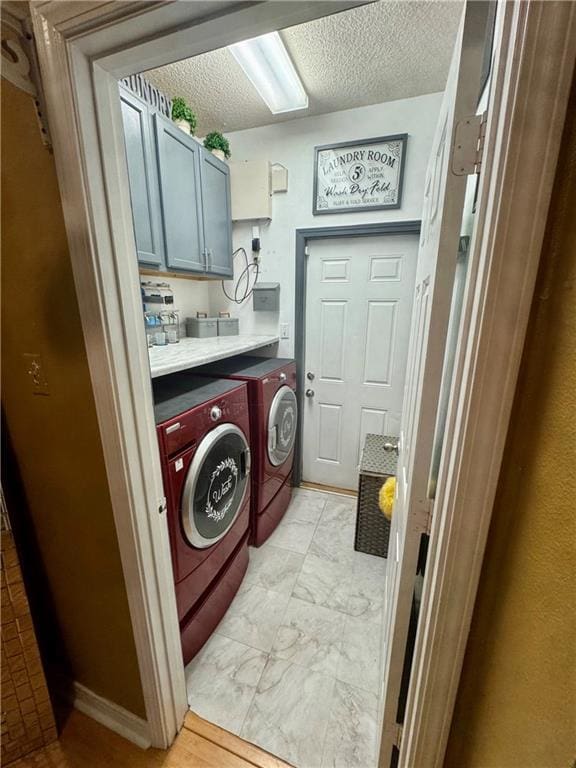 2132 Wellington Ln, Slidell, LA 70461 - laundry area with cabinet space, separate washer and dryer, and a textured ceiling