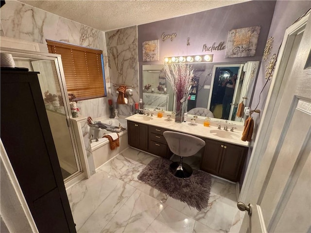 2132 Wellington Ln, Slidell, LA 70461 - bathroom with a textured ceiling, marble finish flooring, a bath, a stall shower, and double vanity