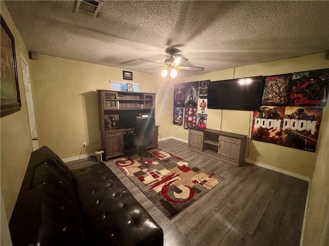 2132 Wellington Ln, Slidell, LA 70461 - game room with a ceiling fan, wood finished floors, baseboards, and a textured ceiling