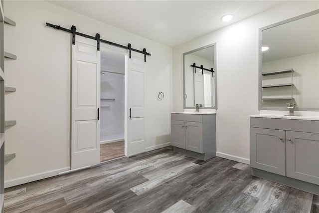 60078 W Park Cir, Lacombe, LA 70445 - full bathroom with wood finished floors, two vanities, recessed lighting, and baseboards