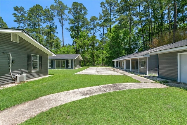 60078 W Park Cir, Lacombe, LA 70445 - view of green lawn featuring a patio and concrete driveway