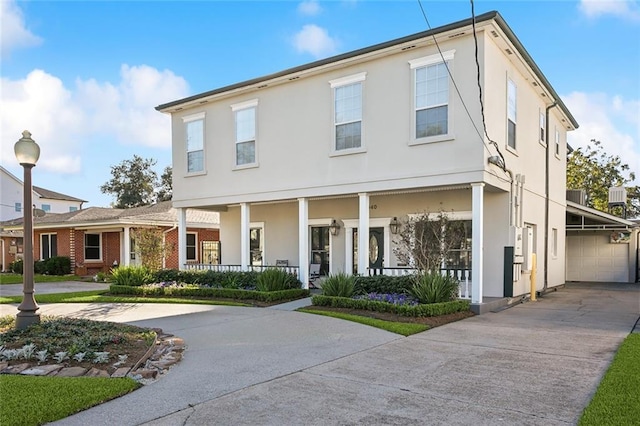 940 Orion Ave, Metairie, LA 70005 - view of front of property featuring covered porch, concrete driveway, stucco siding, and a garage