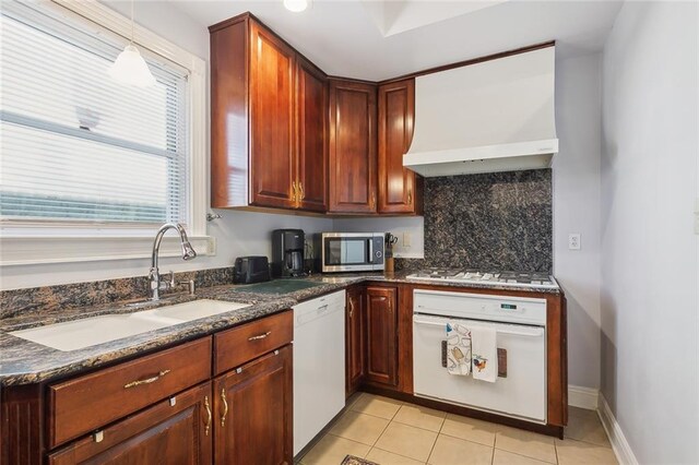 940 Orion Ave, Metairie, LA 70005 - kitchen featuring white appliances, a sink, premium range hood, tasteful backsplash, and light tile patterned floors