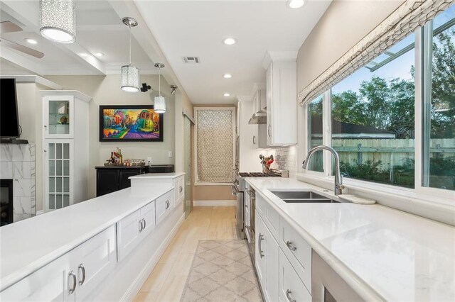 940 Orion Ave, Metairie, LA 70005 - kitchen with plenty of natural light, white cabinets, light countertops, and recessed lighting