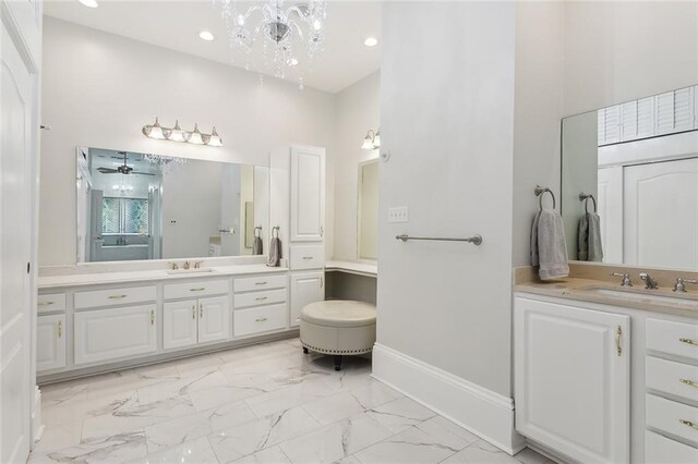 940 Orion Ave, Metairie, LA 70005 - bathroom with marble finish flooring, two vanities, a chandelier, recessed lighting, and a ceiling fan