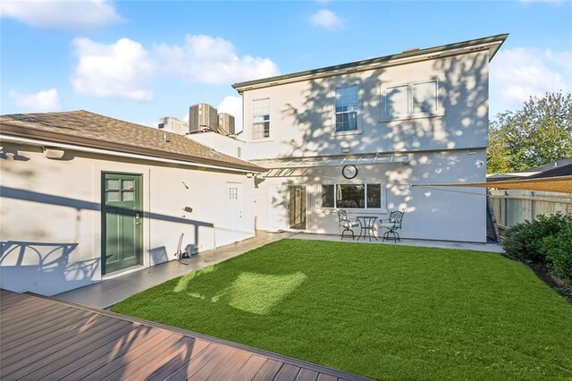 940 Orion Ave, Metairie, LA 70005 - back of property featuring stucco siding, central AC unit, a patio area, and a deck