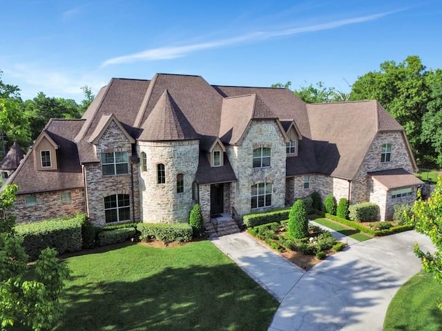 11 Arbor Cir, New Orleans, LA 70131 - french country style house featuring stone siding and a front yard