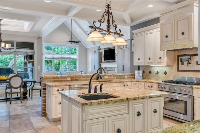 11 Arbor Cir, New Orleans, LA 70131 - kitchen with high end stainless steel range, a sink, cream cabinetry, a peninsula, and backsplash