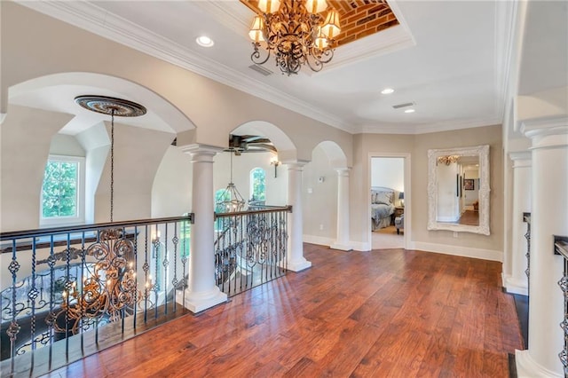 11 Arbor Cir, New Orleans, LA 70131 - hall with a chandelier, decorative columns, wood finished floors, an upstairs landing, and crown molding