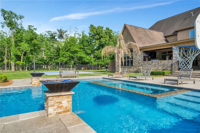 11 Arbor Cir, New Orleans, LA 70131 - view of swimming pool with fence, a patio, a pool with connected hot tub, and view of scattered trees