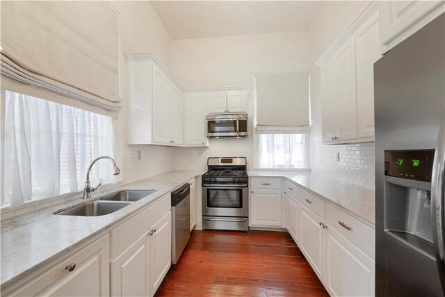 912 Spain St, New Orleans, LA 70117 - kitchen featuring appliances with stainless steel finishes, a sink, and white cabinets
