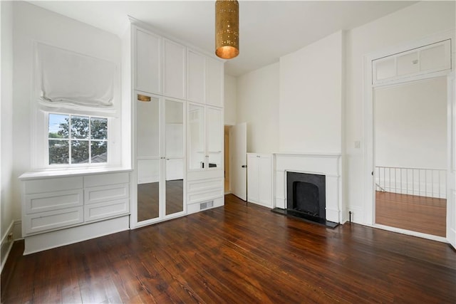 912 Spain St, New Orleans, LA 70117 - unfurnished living room featuring a fireplace and dark wood finished floors
