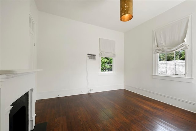 912 Spain St, New Orleans, LA 70117 - unfurnished living room with plenty of natural light, hardwood / wood-style flooring, a large fireplace, and baseboards