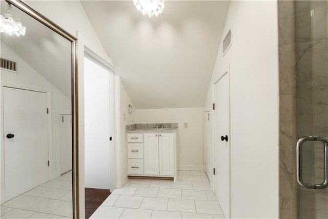 912 Spain St, New Orleans, LA 70117 - bathroom with lofted ceiling, a shower stall, and vanity