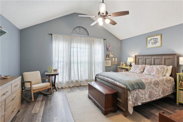 bedroom featuring wood finished floors, lofted ceiling, and a ceiling fan