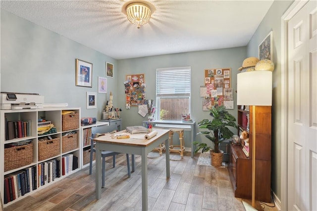 office space featuring light wood-type flooring and baseboards