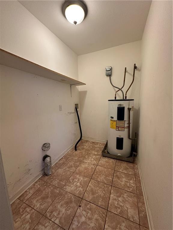 3855 Metropolitan St, New Orleans, LA 70126 - clothes washing area featuring electric water heater, baseboards, hookup for a washing machine, and tile patterned flooring