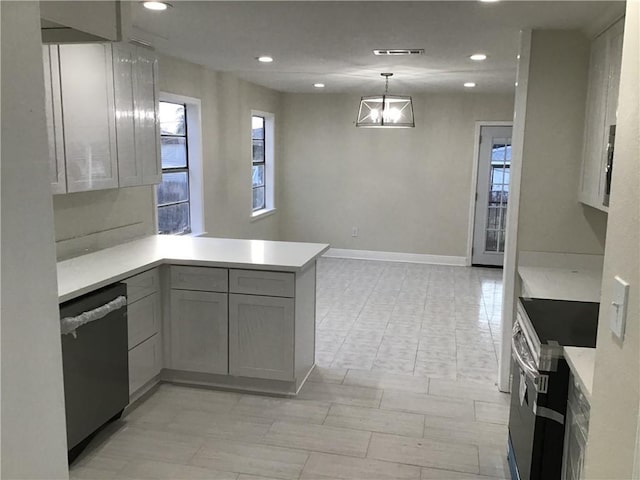 564 Oakwood Dr, Gretna, LA 70056 - kitchen featuring appliances with stainless steel finishes, a peninsula, light countertops, plenty of natural light, and recessed lighting