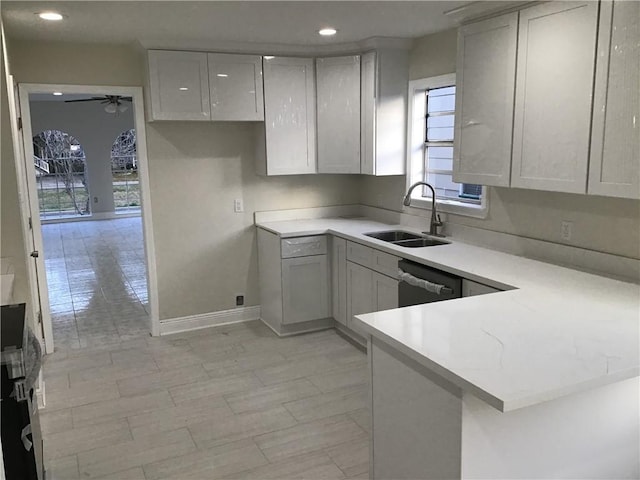 564 Oakwood Dr, Gretna, LA 70056 - kitchen featuring a sink, a ceiling fan, a peninsula, light countertops, and recessed lighting