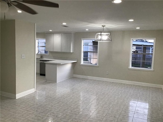 564 Oakwood Dr, Gretna, LA 70056 - kitchen with stainless steel dishwasher, ceiling fan, light countertops, baseboards, and recessed lighting