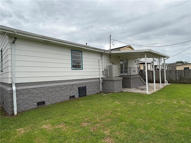 564 Oakwood Dr, Gretna, LA 70056 - rear view of house featuring crawl space, central AC unit, and a patio area