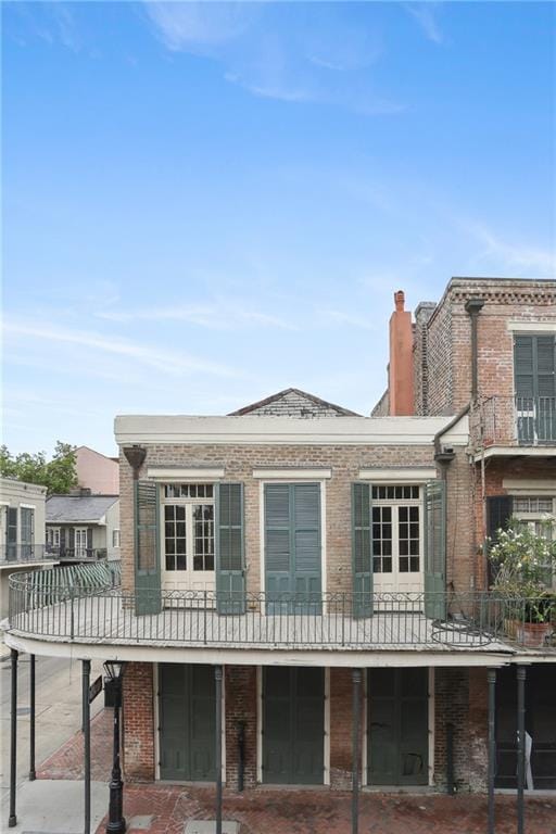 538 Governor Nicholls St, New Orleans, LA 70116 - back of house with brick siding and a chimney