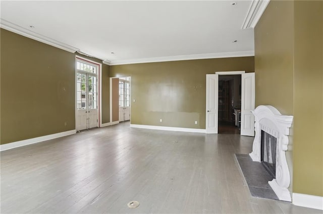 538 Governor Nicholls St, New Orleans, LA 70116 - unfurnished living room featuring ornamental molding, baseboards, a fireplace, and wood finished floors