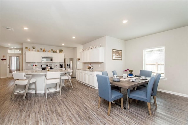 3663 Trestle Crossing Ave, Slidell, LA 70461 - dining room featuring wood finished floors, plenty of natural light, baseboards, and recessed lighting