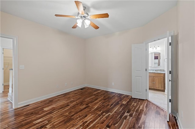 816 Celeste Ave, River Ridge, LA 70123 - unfurnished bedroom with dark wood finished floors, baseboards, connected bathroom, ceiling fan, and a sink