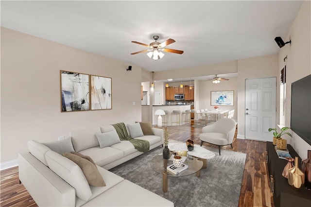 816 Celeste Ave, River Ridge, LA 70123 - living area featuring ceiling fan, dark wood-style floors, and baseboards