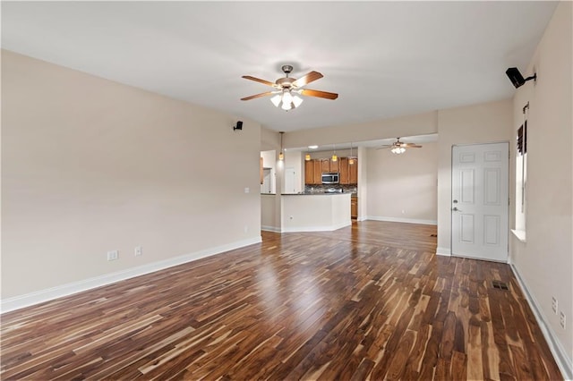 816 Celeste Ave, River Ridge, LA 70123 - unfurnished living room featuring ceiling fan, dark wood finished floors, and baseboards