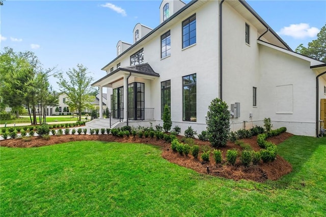 136 Linnette Ln, Mandeville, LA 70471 - rear view of house featuring a yard and stucco siding