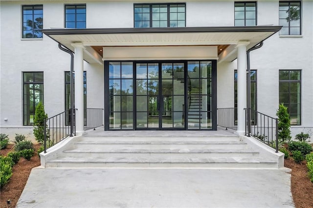 136 Linnette Ln, Mandeville, LA 70471 - doorway to property with stucco siding and a porch