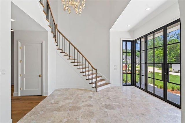 136 Linnette Ln, Mandeville, LA 70471 - foyer with stairway, a chandelier, french doors, recessed lighting, and a towering ceiling