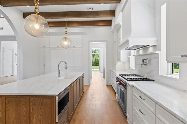 136 Linnette Ln, Mandeville, LA 70471 - kitchen with appliances with stainless steel finishes, a sink, custom range hood, beam ceiling, and white cabinetry