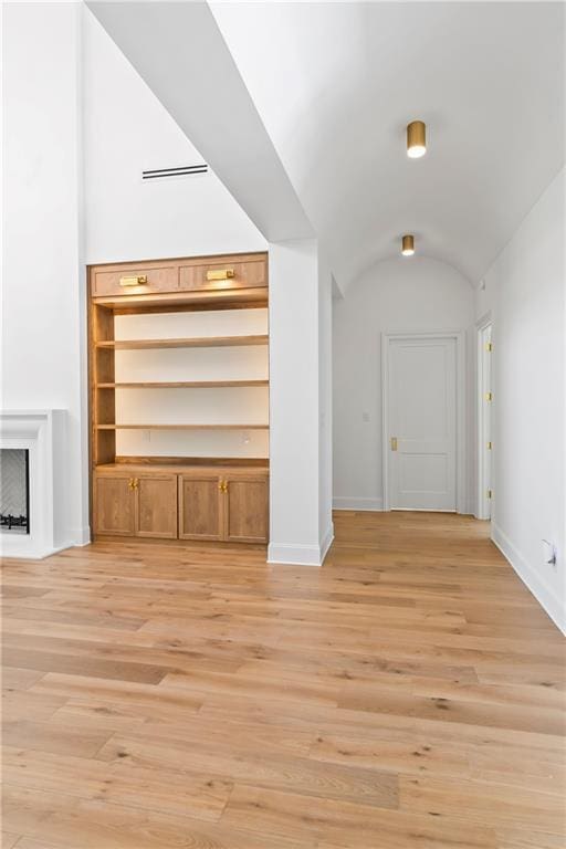 136 Linnette Ln, Mandeville, LA 70471 - unfurnished living room with light wood-style floors, baseboards, and vaulted ceiling