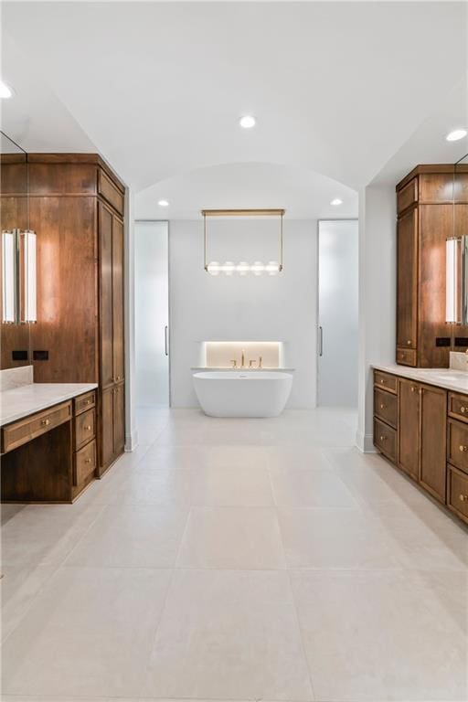 136 Linnette Ln, Mandeville, LA 70471 - bathroom with a soaking tub, recessed lighting, tile patterned flooring, and vanity