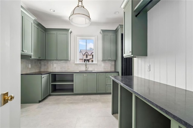 136 Linnette Ln, Mandeville, LA 70471 - kitchen with green cabinetry, dark countertops, decorative backsplash, a sink, and decorative light fixtures