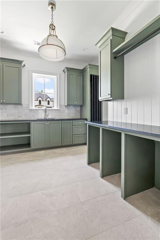 136 Linnette Ln, Mandeville, LA 70471 - kitchen featuring green cabinets, a sink, tasteful backsplash, and ornamental molding