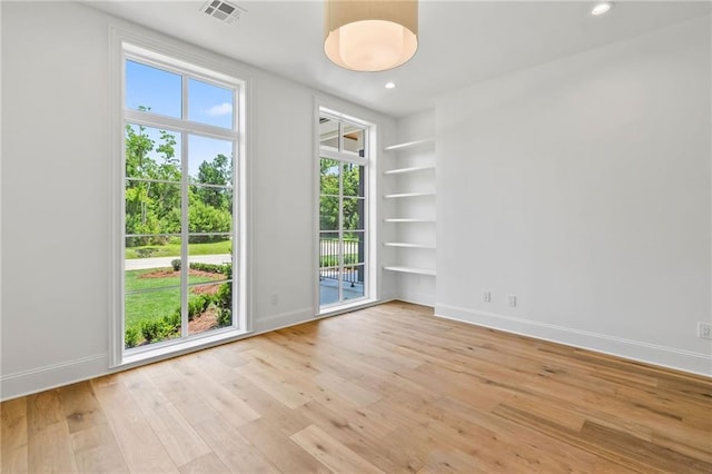 136 Linnette Ln, Mandeville, LA 70471 - empty room with light wood-style flooring, baseboards, healthy amount of natural light, recessed lighting, and built in features