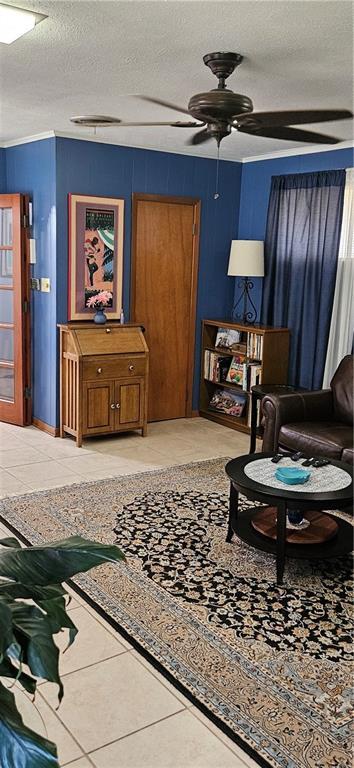 3231 47th St, Metairie, LA 70001 - living room with a textured ceiling, tile patterned floors, and ceiling fan